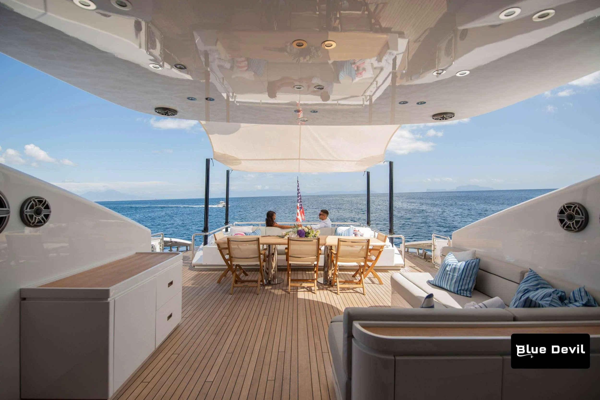 a boat with a table and chairs aboard BLUE DEVIL Yacht for Sale