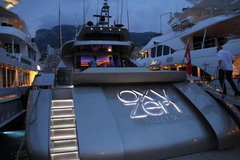 a military boat with a flag on the front aboard BLUE DEVIL Yacht for Sale