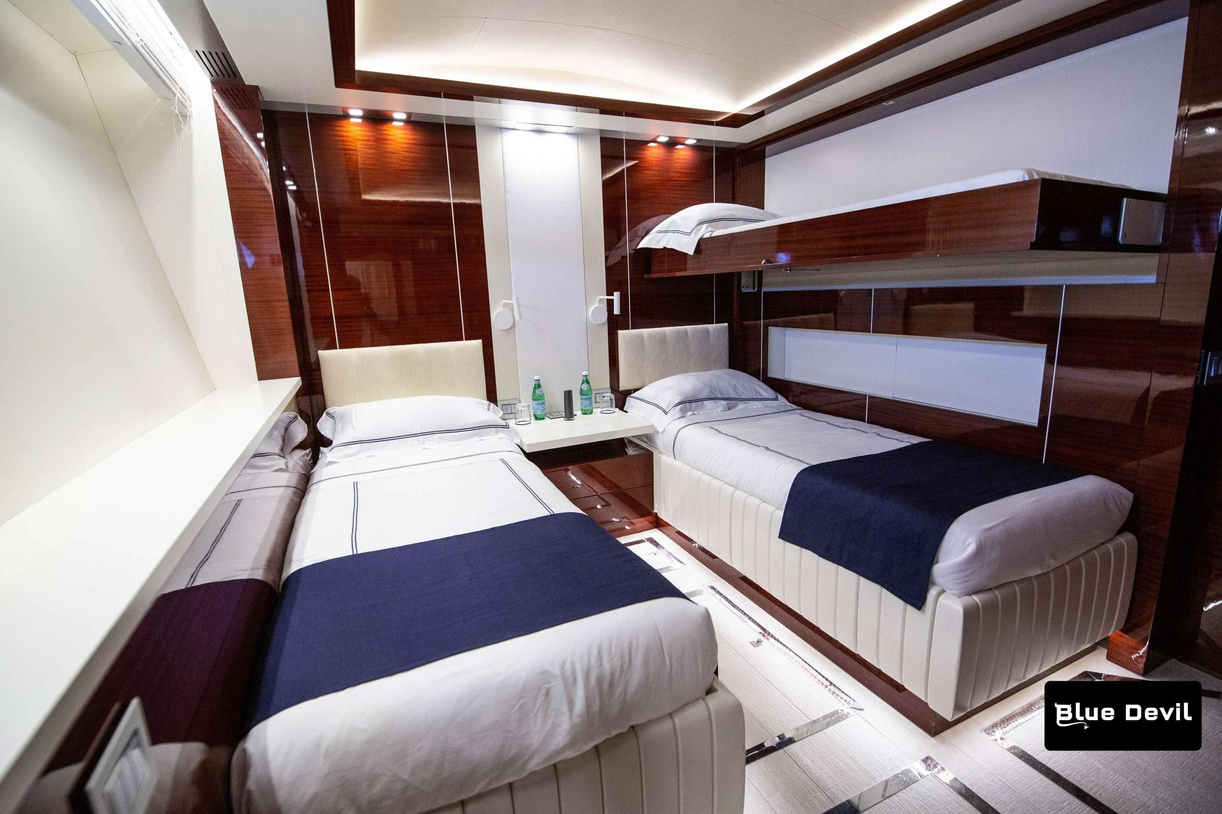 a room with beds and a window aboard BLUE DEVIL Yacht for Sale