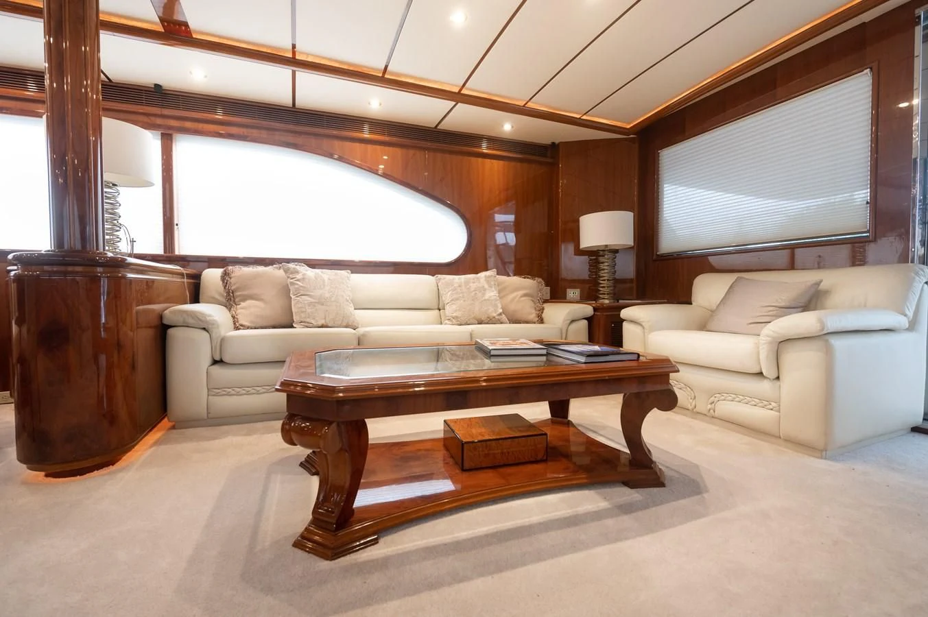 a living room with a couch and a coffee table aboard DOLCE VITA Yacht for Sale