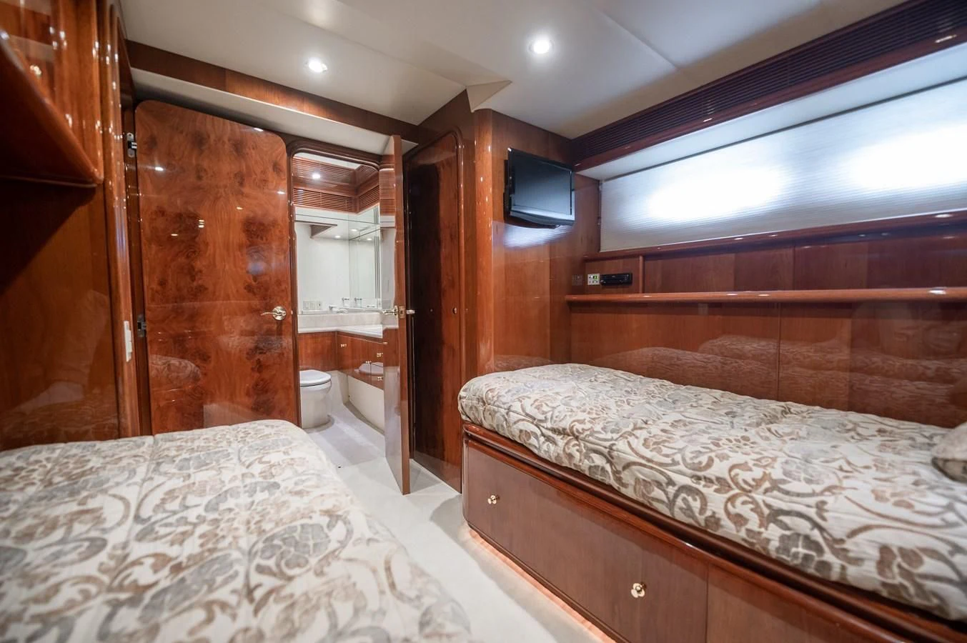 a room with a bed and a television aboard DOLCE VITA Yacht for Sale