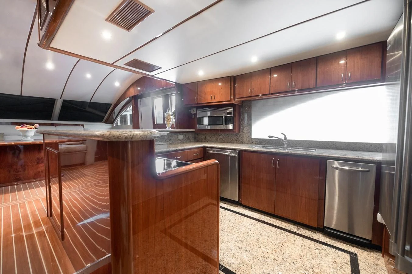 a kitchen with wooden cabinets aboard DOLCE VITA Yacht for Sale