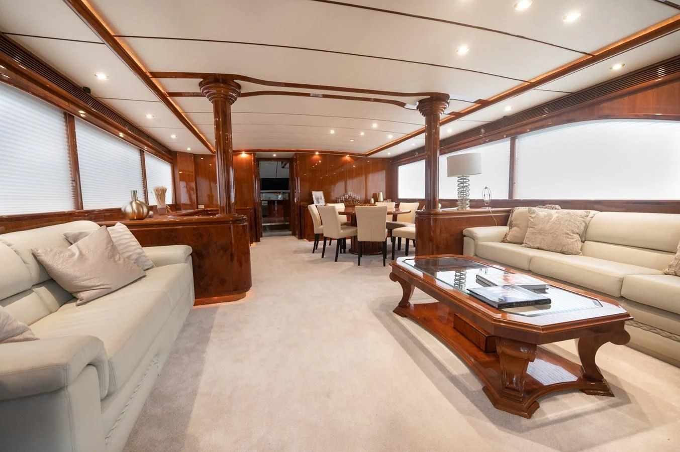 a living room with a couch and a coffee table aboard DOLCE VITA Yacht for Sale