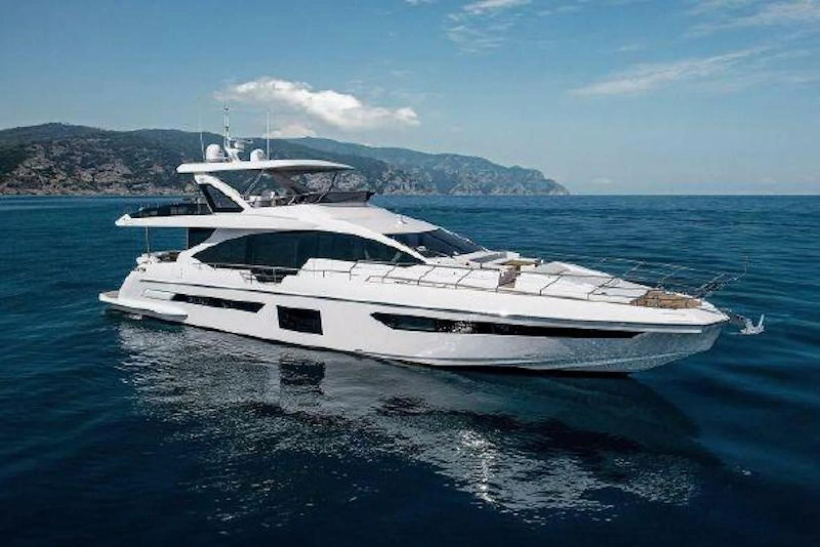 a white yacht in the water aboard NOMAD Yacht for Sale