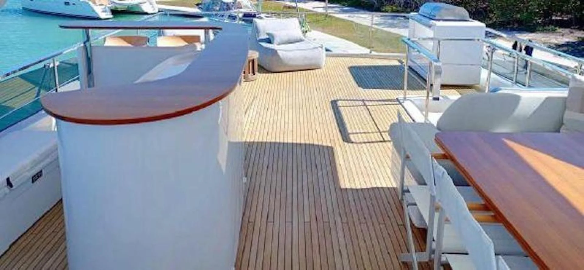 a deck with a table and chairs aboard NOMAD Yacht for Sale