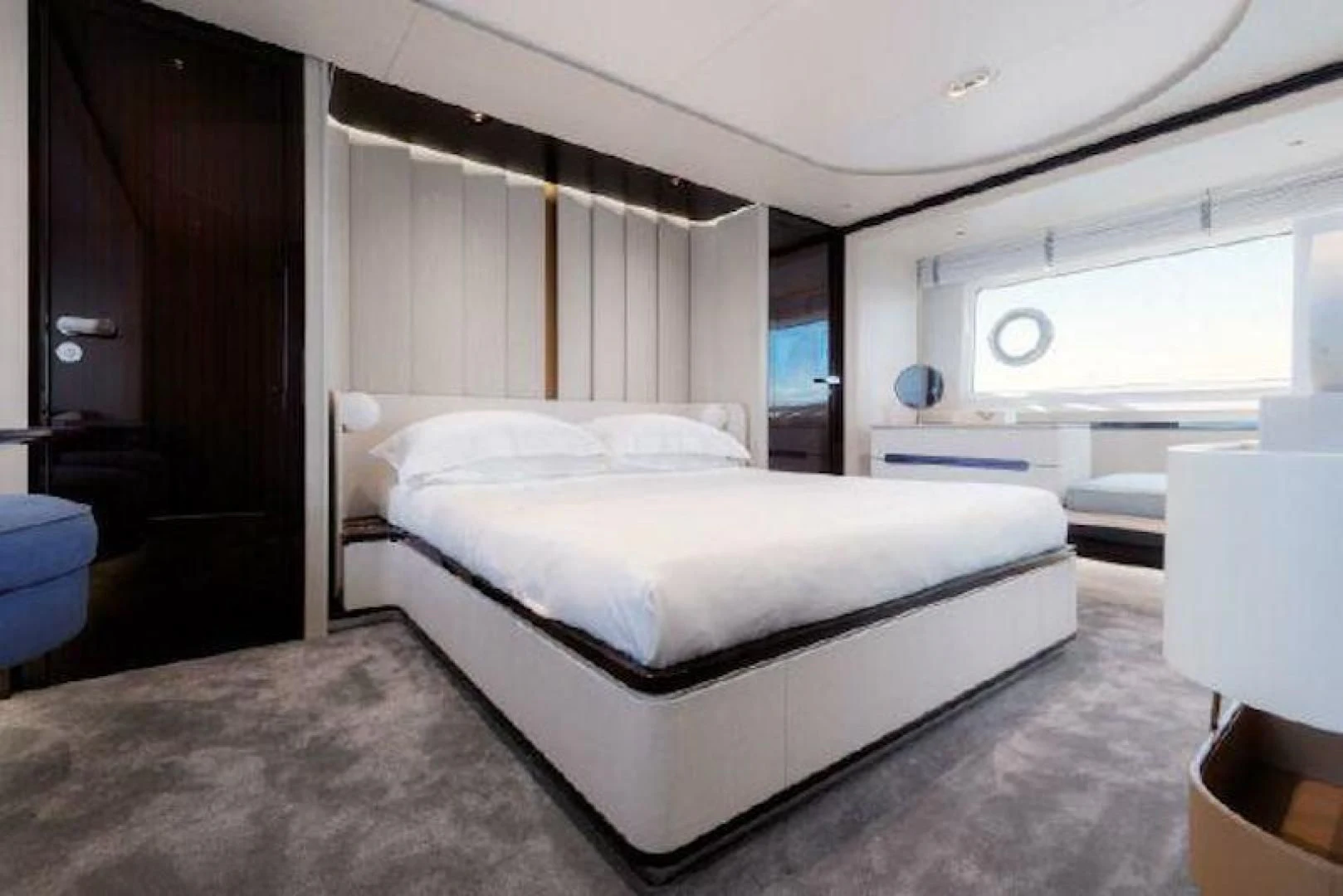 a room with a bed and a window aboard NOMAD Yacht for Sale