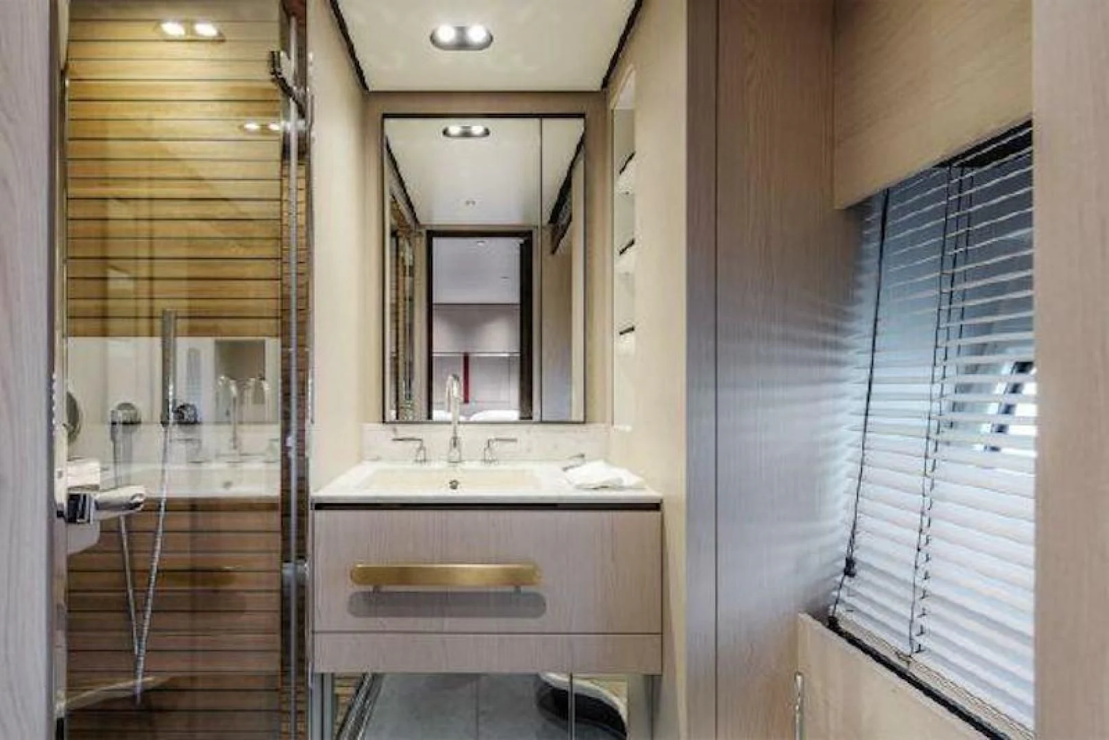 a bathroom with a sink and a mirror aboard NOMAD Yacht for Sale