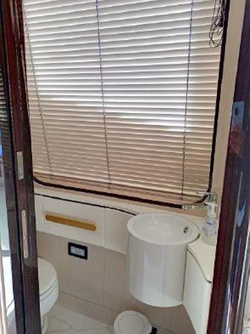 a bathroom with a toilet and a sink aboard NOMAD Yacht for Sale