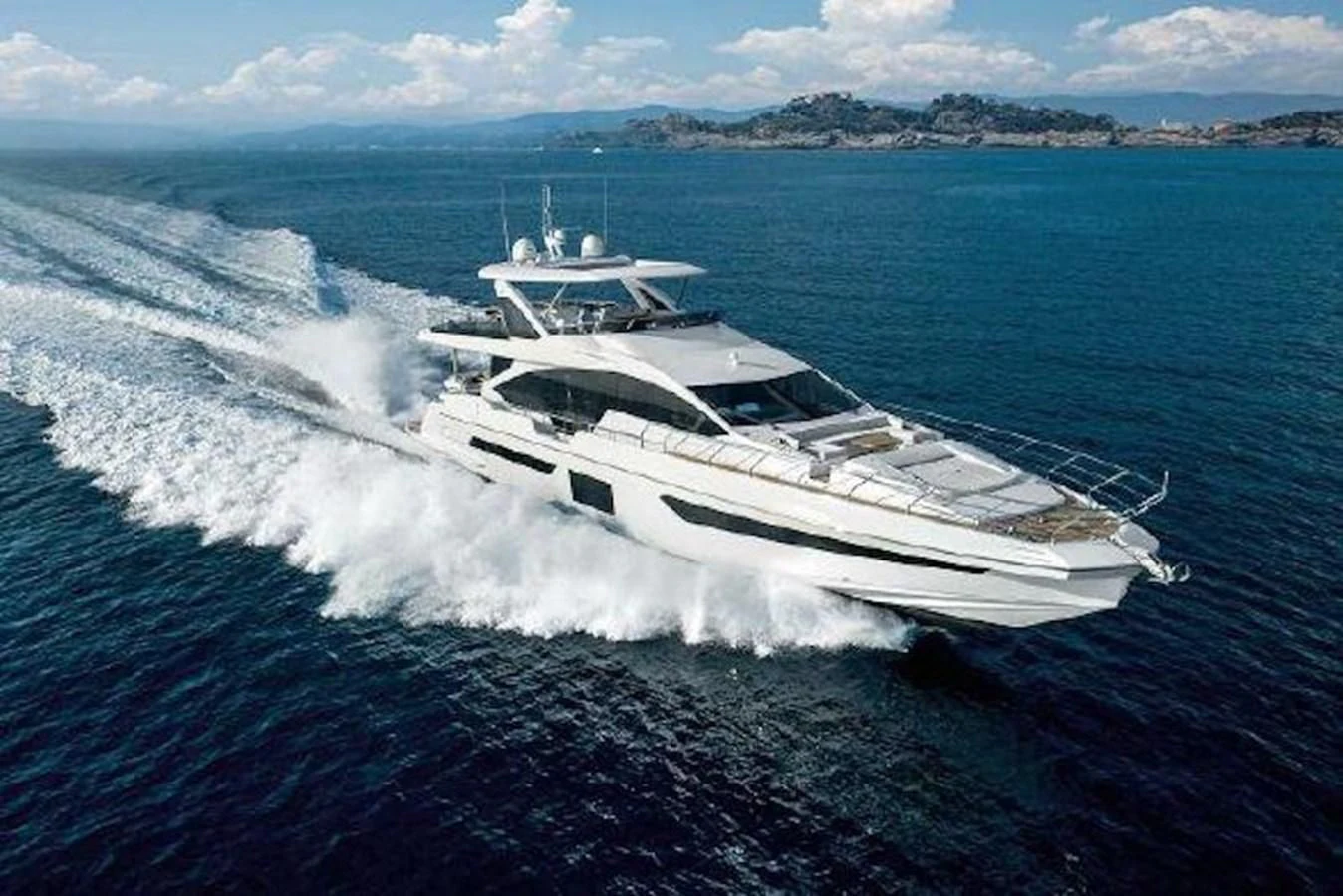 a white yacht on the water aboard NOMAD Yacht for Sale