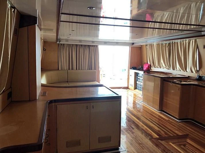 a room with a wood floor and cabinets and a window aboard BLUE DOLPHIN Yacht for Sale