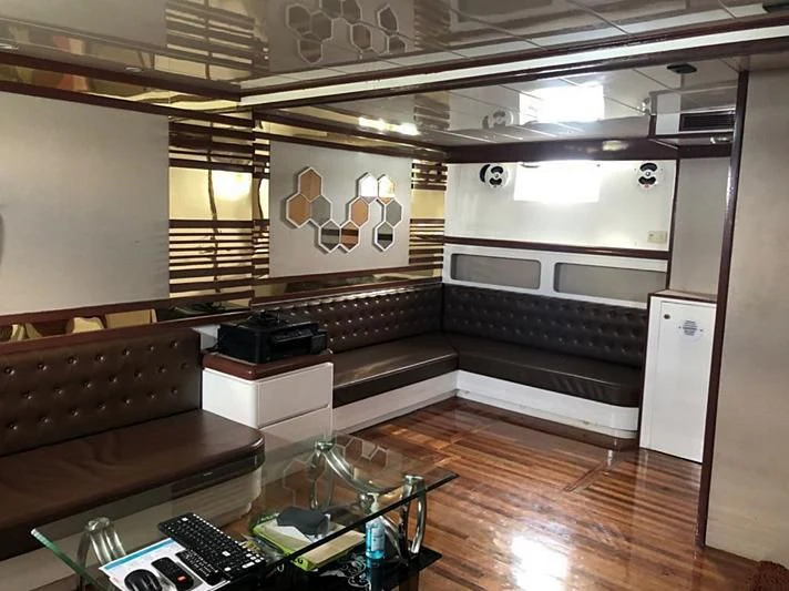 a room with a couch and a coffee table aboard BLUE DOLPHIN Yacht for Sale