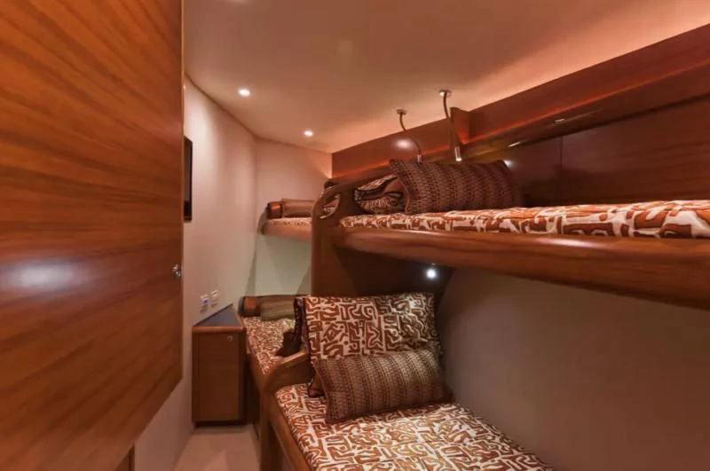 a bed with a wood headboard aboard ISLAMAR Yacht for Sale