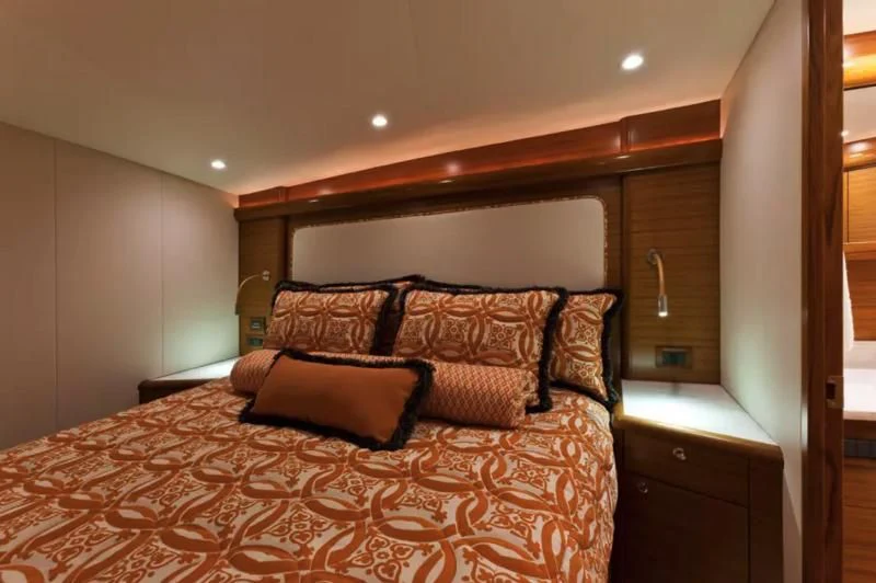 a bed with a brown comforter aboard ISLAMAR Yacht for Sale