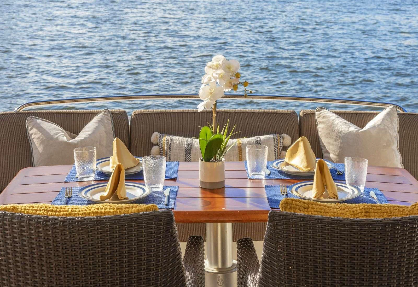 a table with a plant on it aboard UNFORGETTABLE Yacht for Sale
