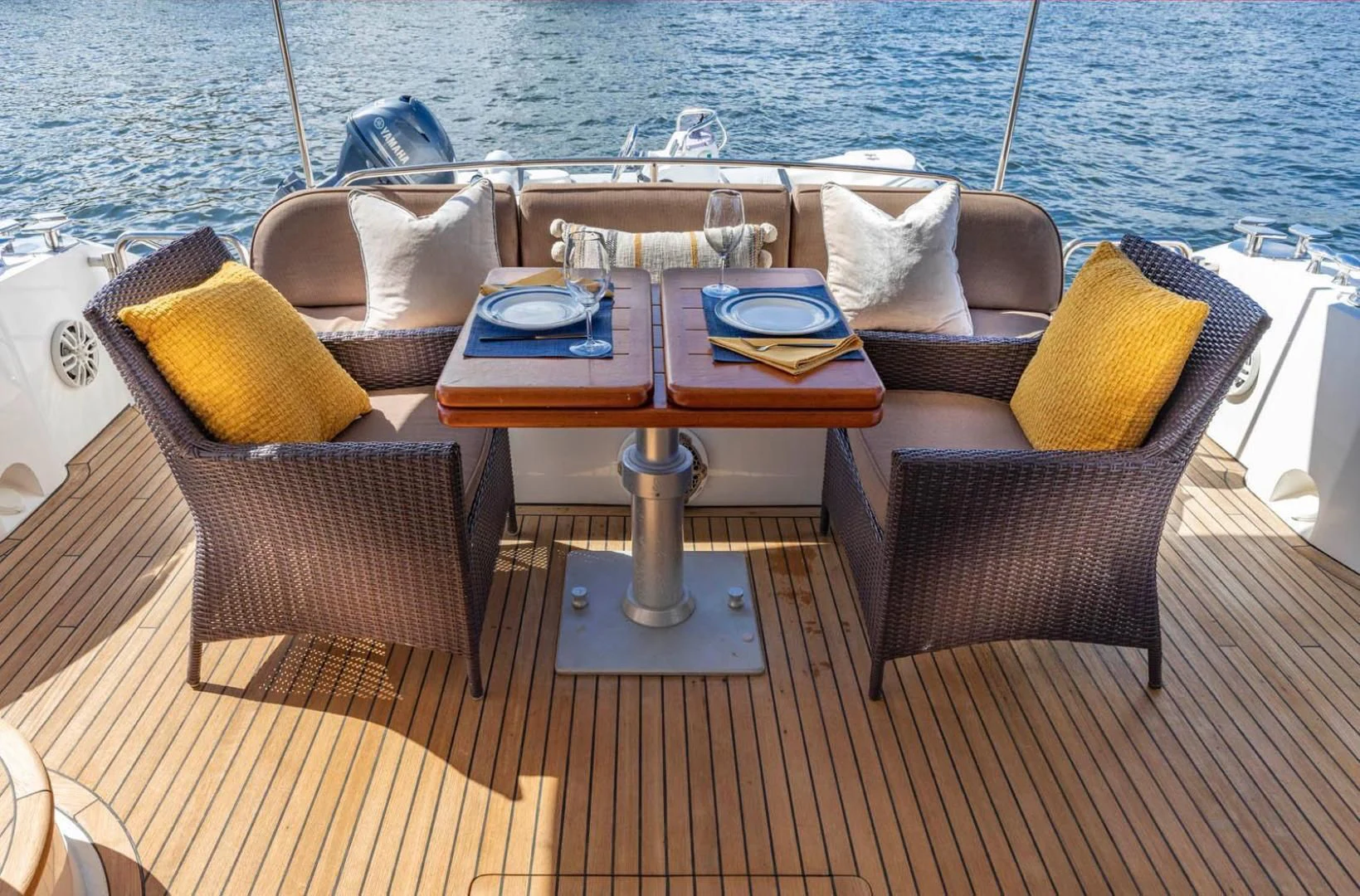 a table and chairs on a deck aboard UNFORGETTABLE Yacht for Sale
