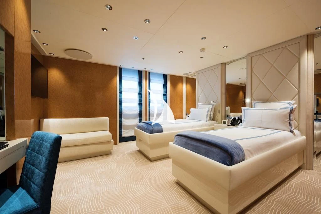 a room with a bed and a window aboard QUEEN MIRI Yacht for Sale