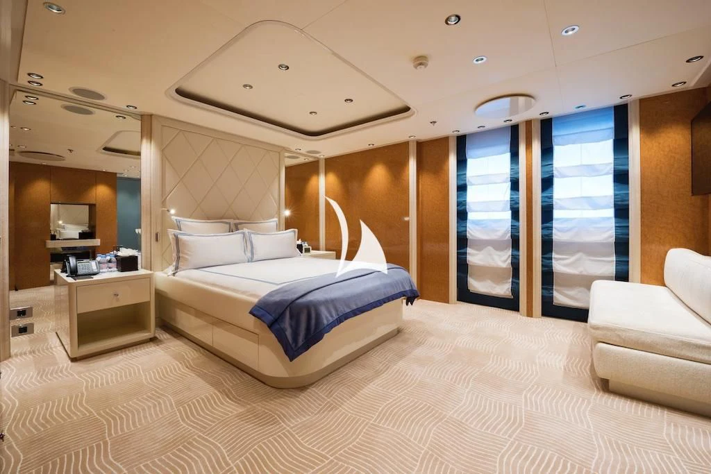 a bedroom with a bed and a large window aboard QUEEN MIRI Yacht for Sale