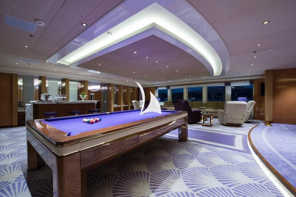 a room with a bed and a desk aboard QUEEN MIRI Yacht for Sale