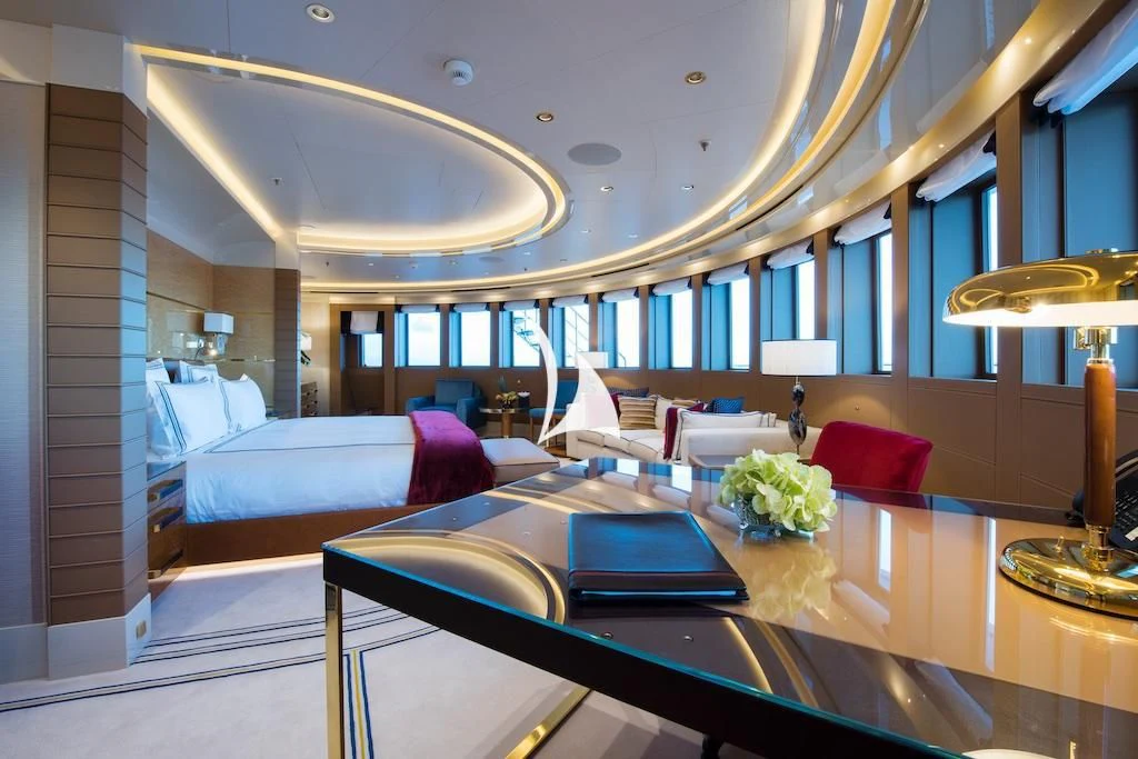a large room with a table and chairs aboard QUEEN MIRI Yacht for Sale