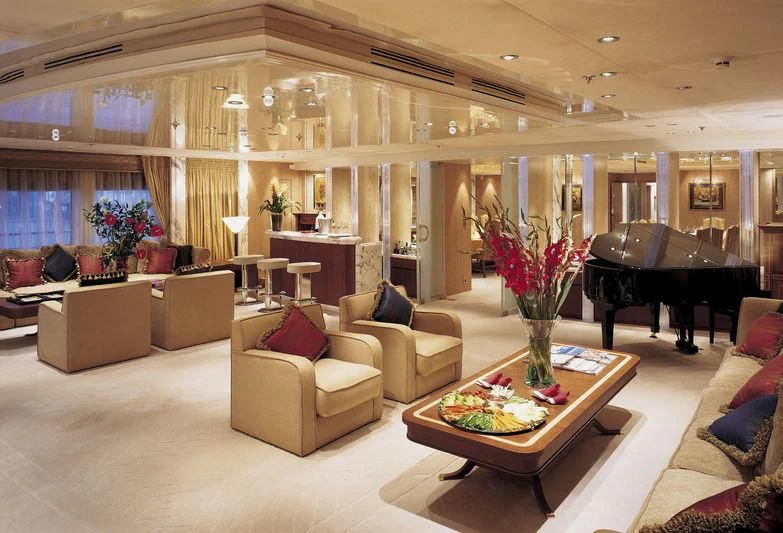 a living room with a piano and a piano aboard QUEEN MIRI Yacht for Sale