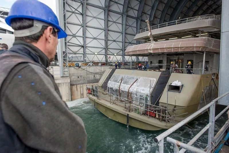 a man looking at a ship aboard QUEEN MIRI Yacht for Sale