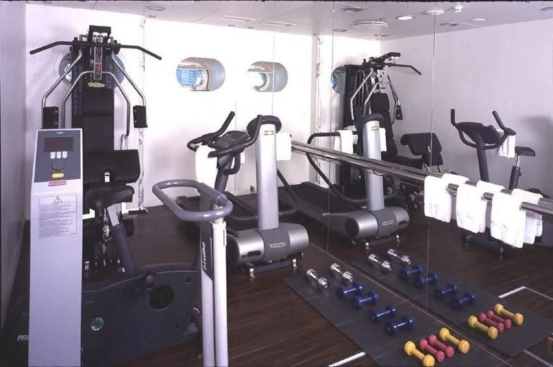 a room with many exercise equipment aboard QUEEN MIRI Yacht for Sale