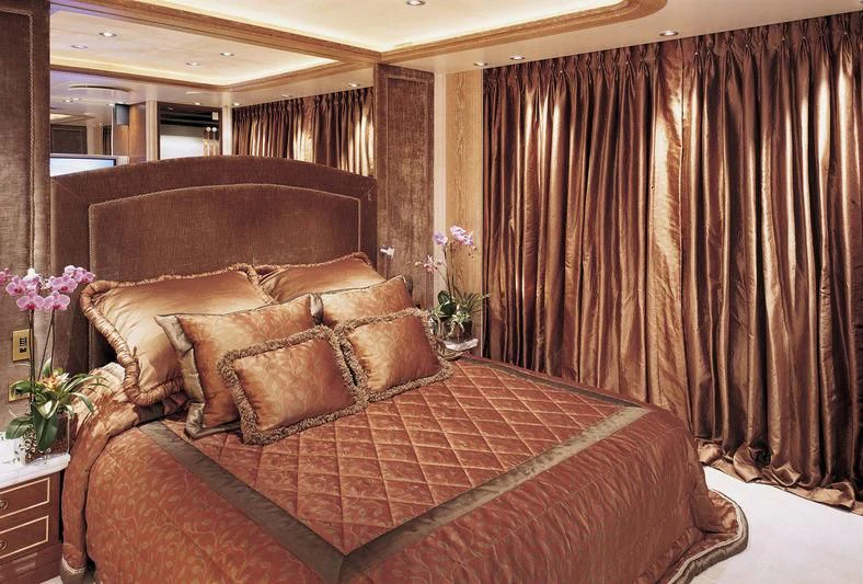 a bed with a brown comforter aboard QUEEN MIRI Yacht for Sale