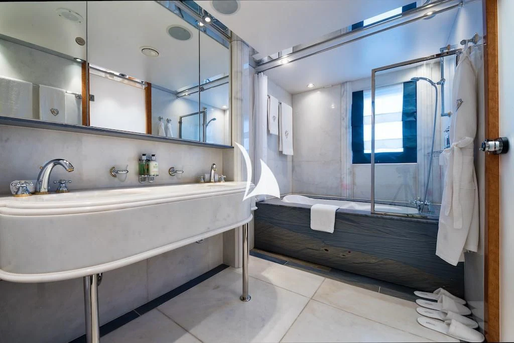 a bathroom with a tub sink and a mirror aboard QUEEN MIRI Yacht for Sale