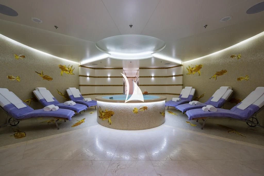 a room with a round table and a white lamp aboard QUEEN MIRI Yacht for Sale