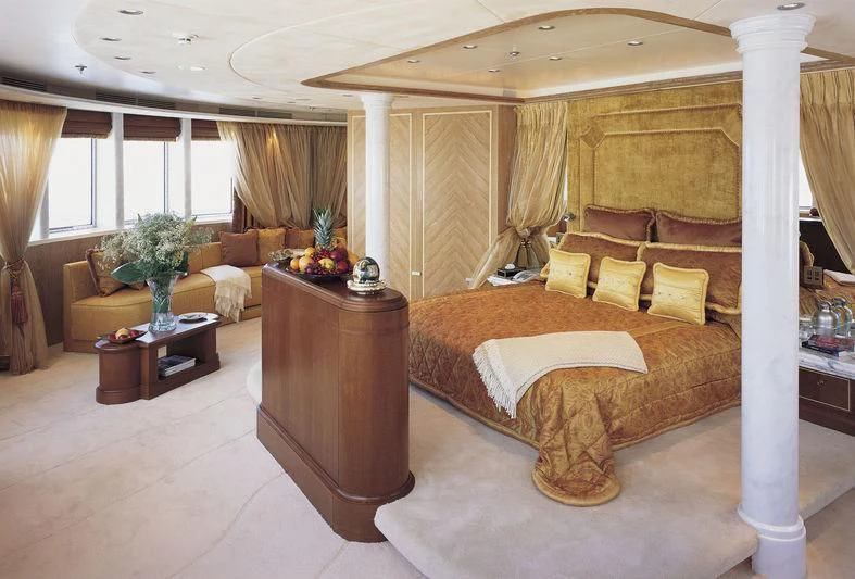 a large bed in a room aboard QUEEN MIRI Yacht for Sale