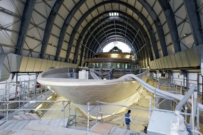 a large space shuttle in a hangar aboard QUEEN MIRI Yacht for Sale