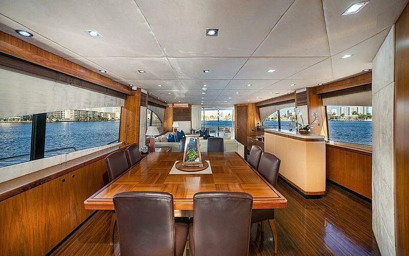 a large room with a table and chairs aboard BEYOND Yacht for Sale