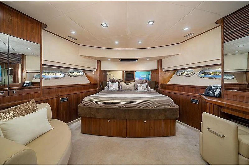 a bedroom with a bed and a desk aboard BEYOND Yacht for Sale