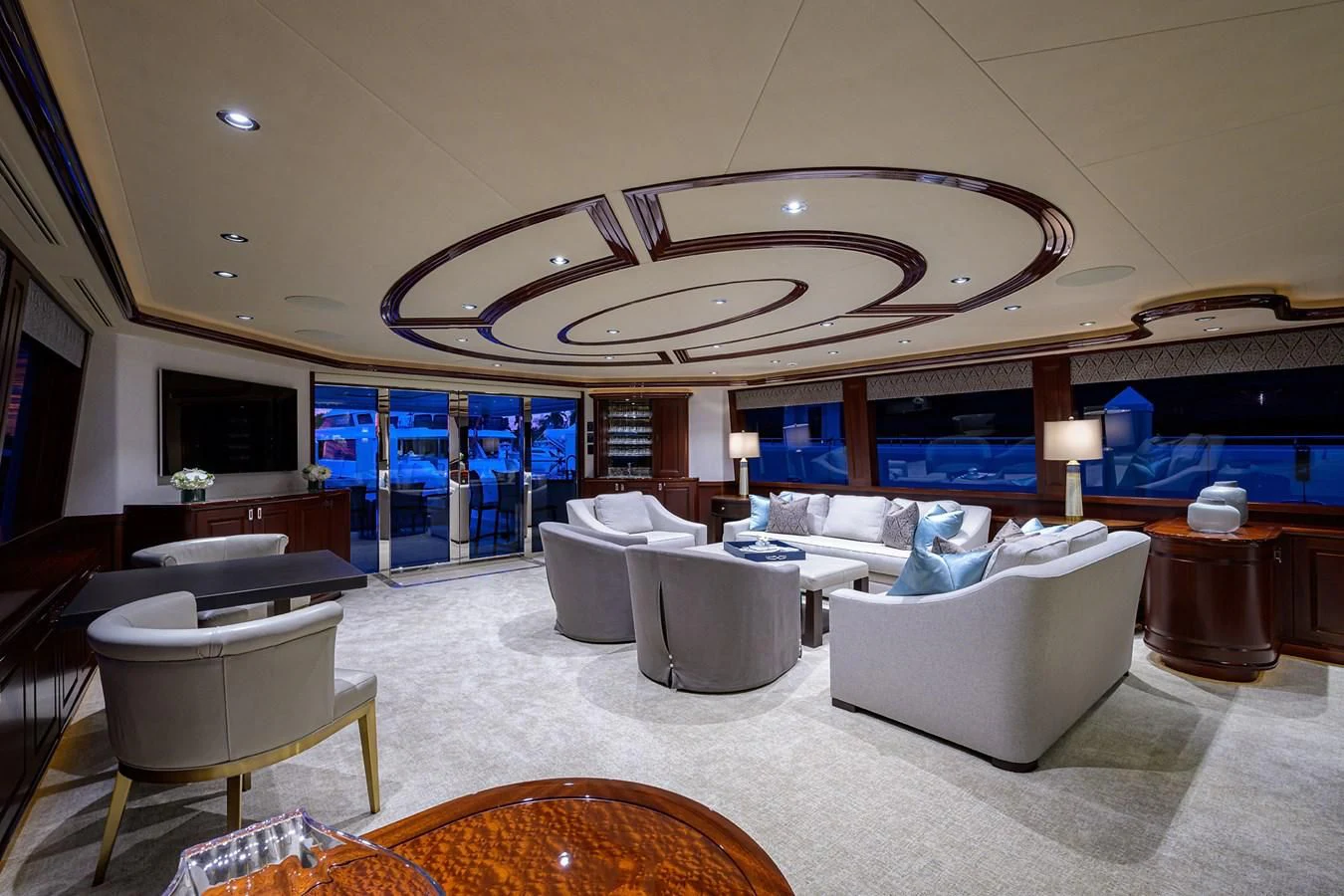 a large living room with a large chandelier aboard DETERMINATION Yacht for Sale