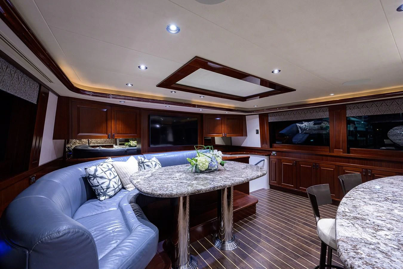 a living room with a table and chairs aboard DETERMINATION Yacht for Sale