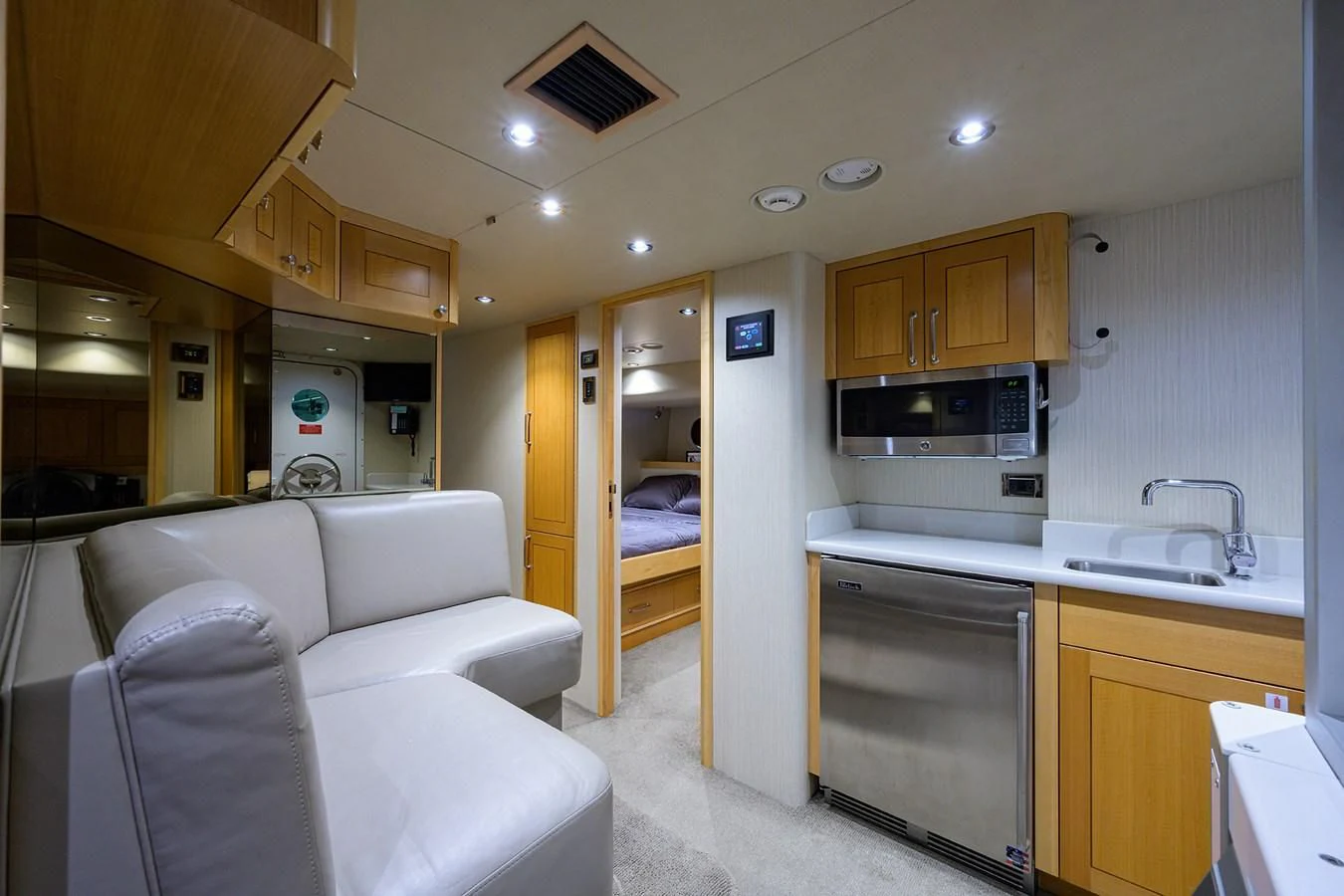 a room with a bed and a couch aboard DETERMINATION Yacht for Sale