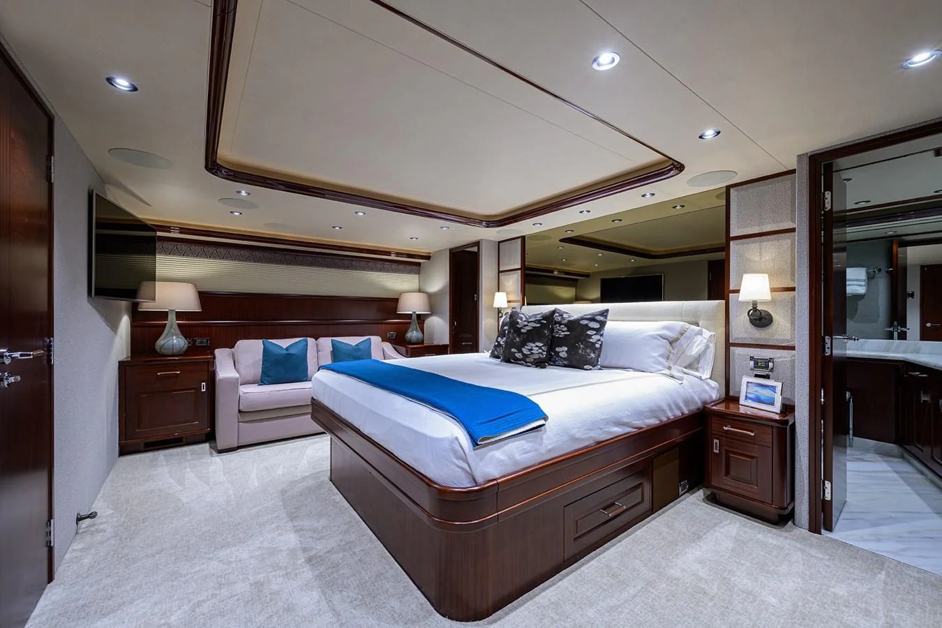 a hotel room with a bed and a mirror aboard DETERMINATION Yacht for Sale