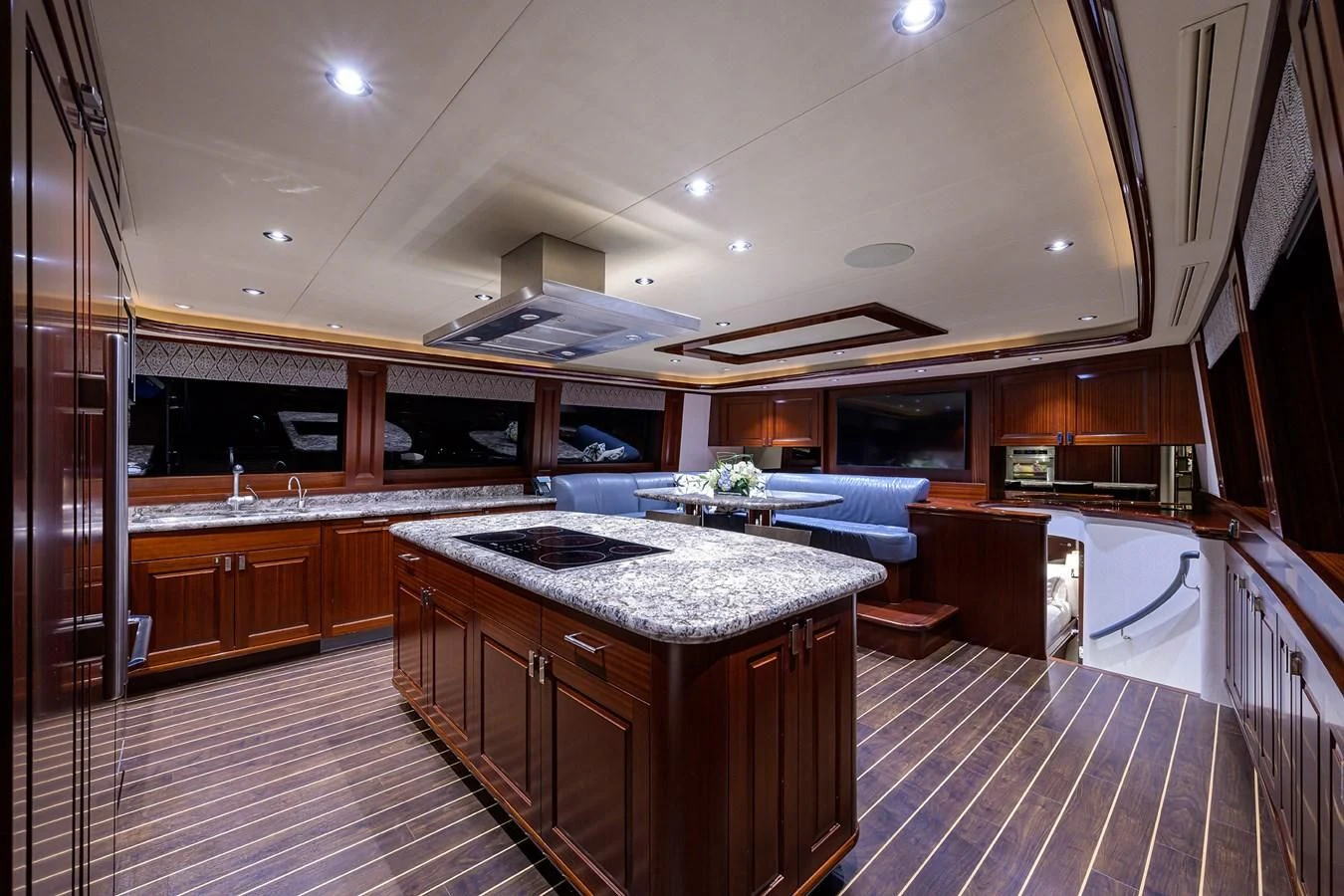 a kitchen with wooden cabinets aboard DETERMINATION Yacht for Sale
