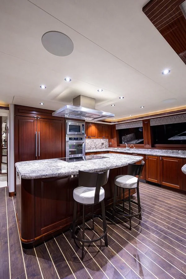 a kitchen with a bar and stools aboard DETERMINATION Yacht for Sale