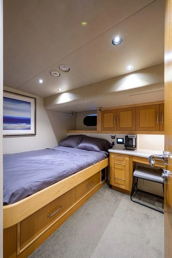 a bedroom with a bed and a desk aboard DETERMINATION Yacht for Sale