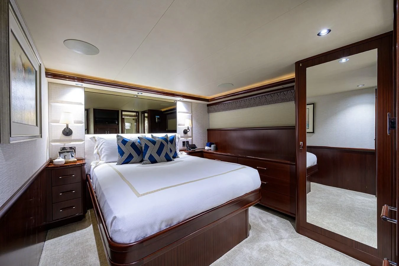 a bedroom with a bed and a mirror aboard DETERMINATION Yacht for Sale