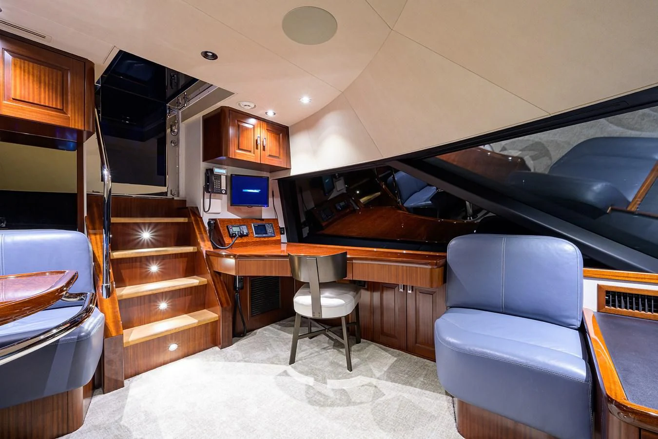 a living room with a piano aboard DETERMINATION Yacht for Sale