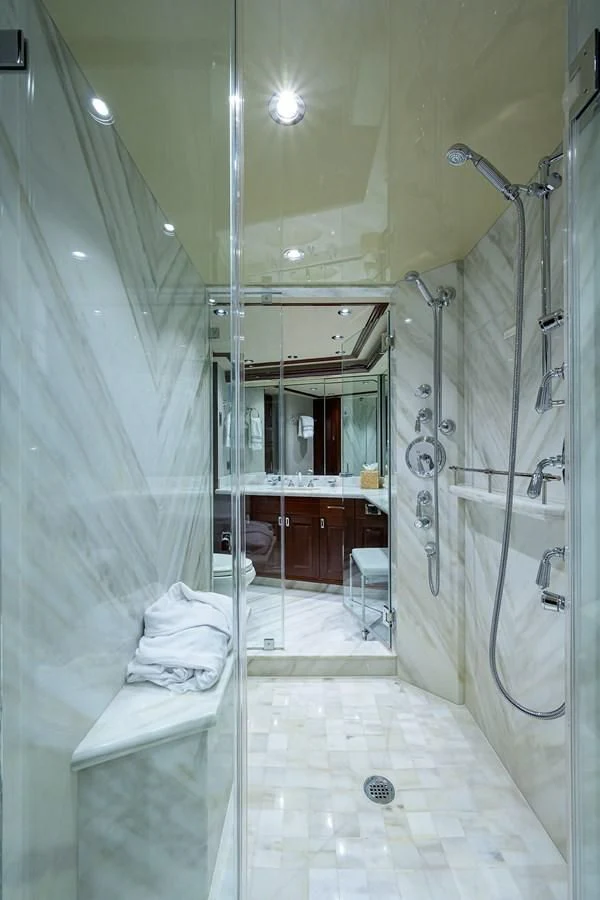a bathroom with a glass shower aboard DETERMINATION Yacht for Sale