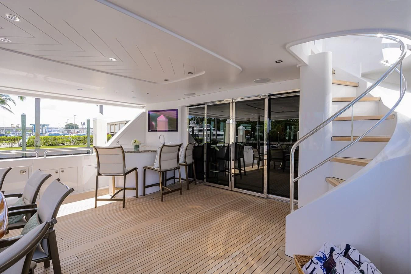 a room with a table chairs and a staircase aboard DETERMINATION Yacht for Sale