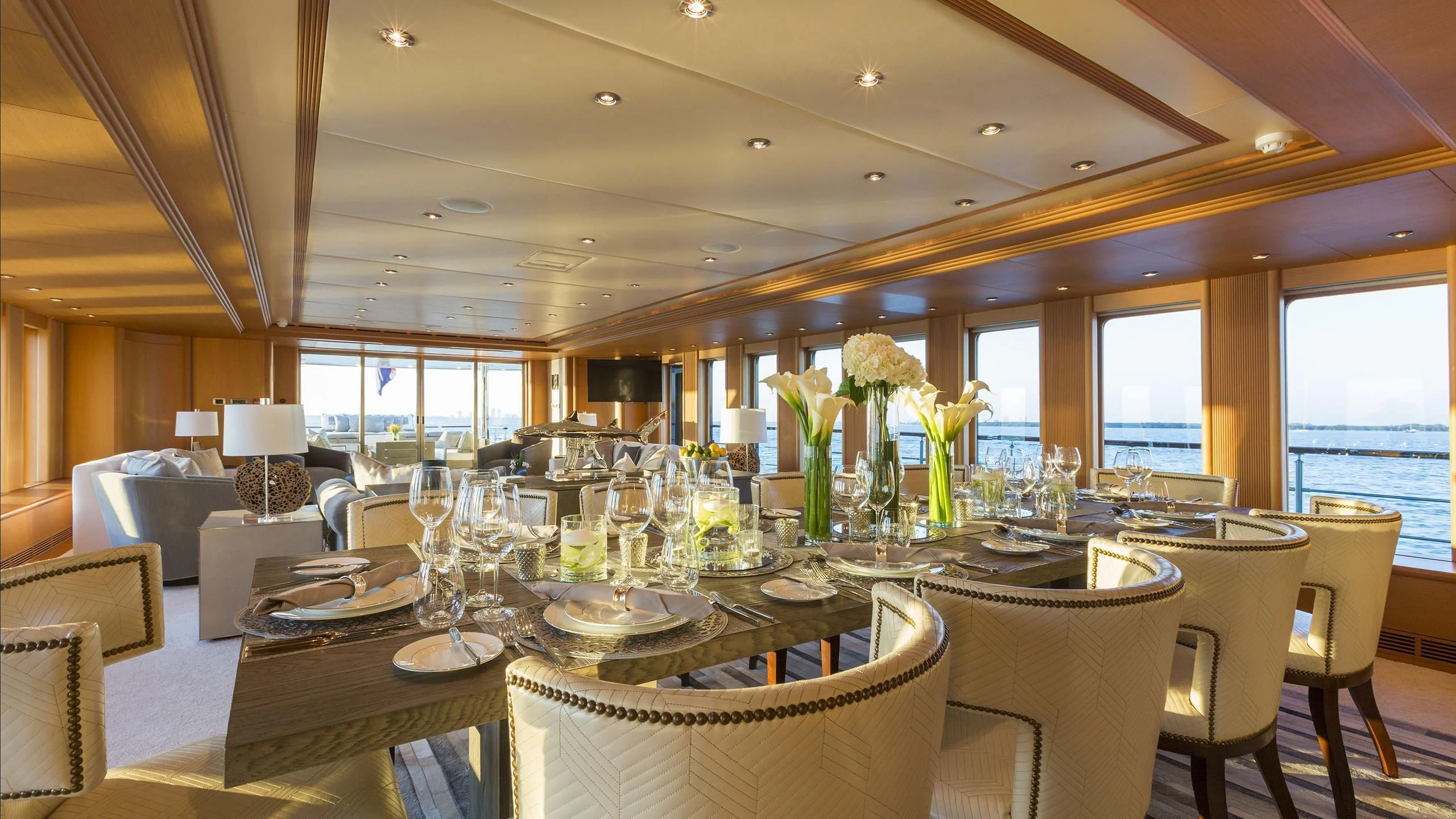 a dining room with a table set for a formal dinner aboard DEDE Yacht for Sale