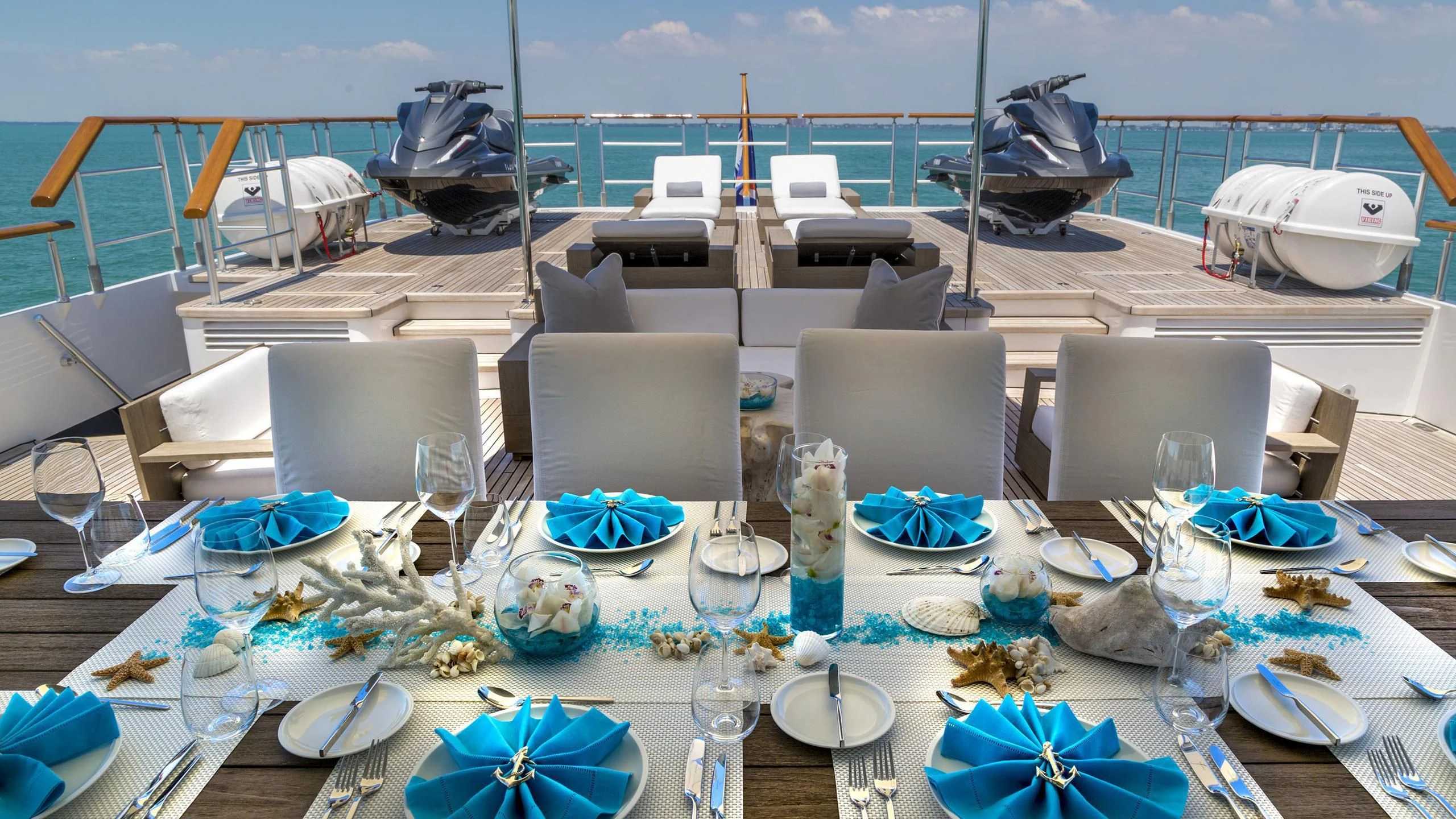 a table set for a dinner party aboard DEDE Yacht for Sale