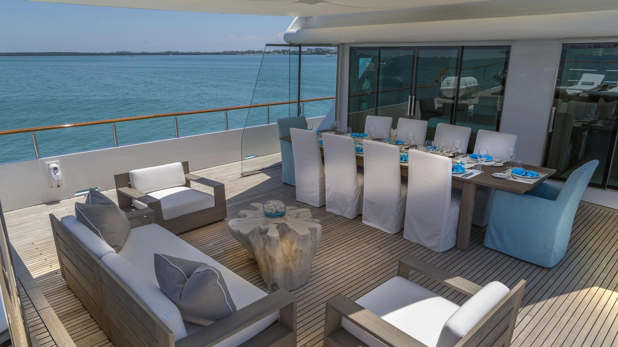 a room with a table chairs and a large body of water aboard DEDE Yacht for Sale