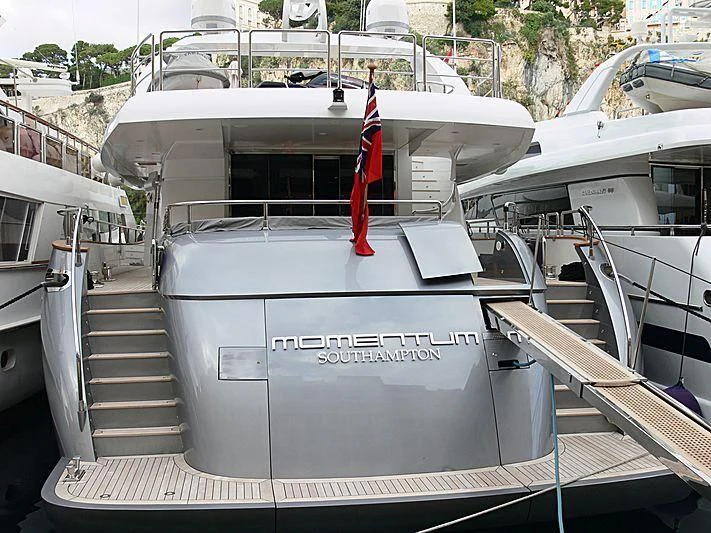 a large grey boat with a red ribbon on the front aboard KHALILI Yacht for Sale