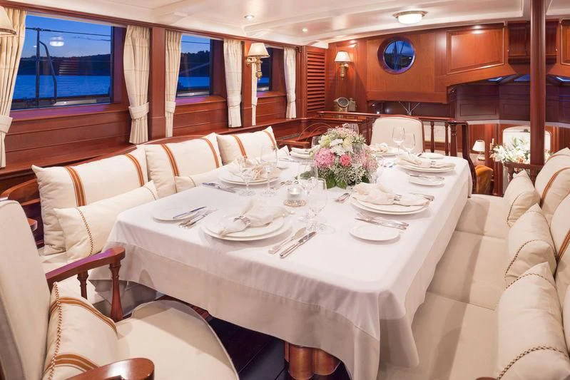 a large dining room with white tables aboard KAMAXITHA Yacht for Sale