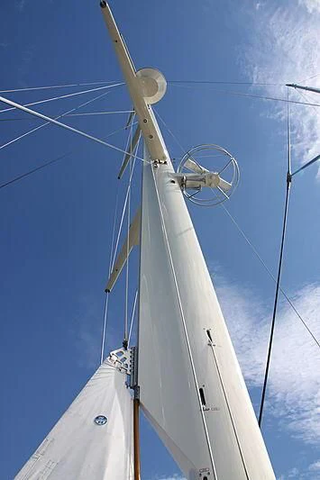 a white boat with a round wheel aboard KAMAXITHA Yacht for Sale
